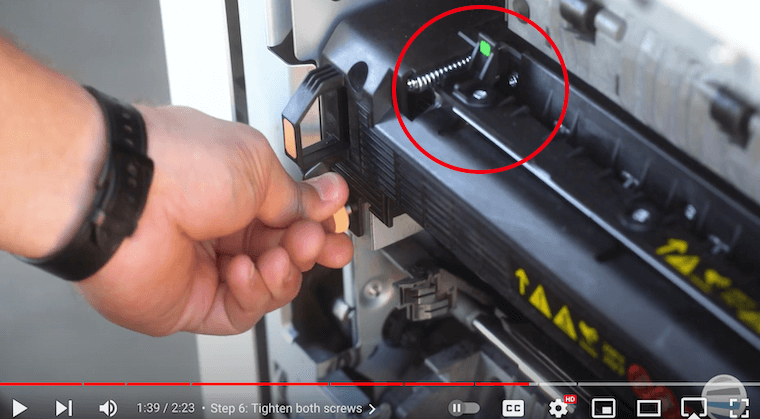 Printer technician locks the green handle on a Xerox AltaLink B8090 Printer