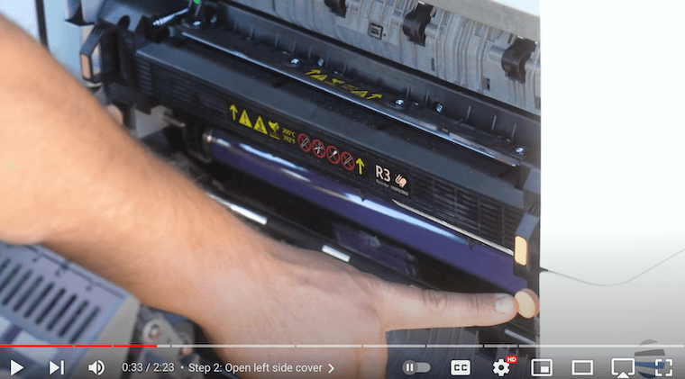 Printer technician loosens the screws on a Xerox AltaLink B8090 Printer