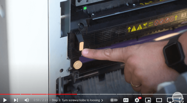 Printer technician removes the old fuser on a Xerox AltaLink B8090 Printer