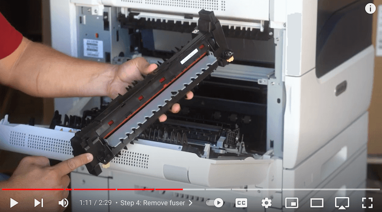 Printer technician inserts the new fuser by the ends on the Xerox VersaLink C7020/C7025/C7030 Printer