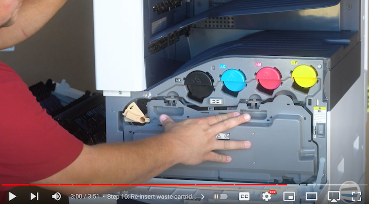 Printer technician re-inserts waste cartridge on Xerox VersaLink C7020/C7025/C7030